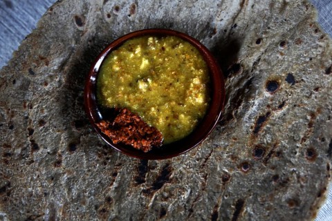 Ensete bread patties with a bowl of yellow sauce in Dorze village, Dorze village, Ethiopia