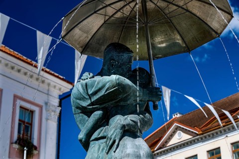 Close-up view of the sculpture of students kissing with umbrella, a landmark of Tartu, against the
