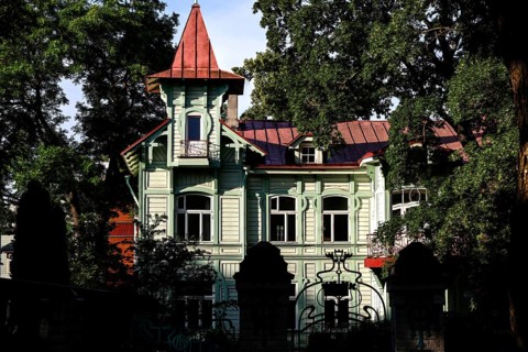 Classic wooden house with tower surrounded by dense forest, Tallinn, Estonia