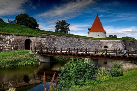 Medieval castle with bridge and moat surrounded by green countryside, Kuressaare, Saaremaa, Estonia