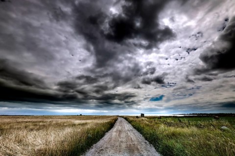 Dramatic clouds over a straight road through Vilsandi National Park, Vilsandi National Park,