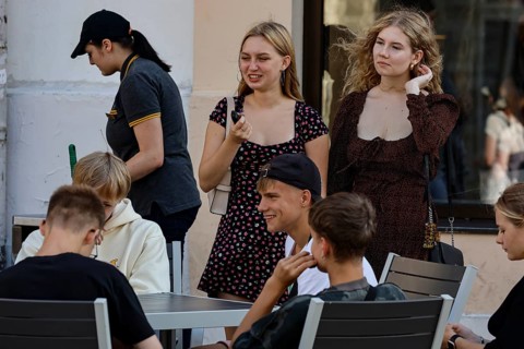 Young people relax and enjoy the sunny atmosphere on the street, Tallinn, Harju, Estonia