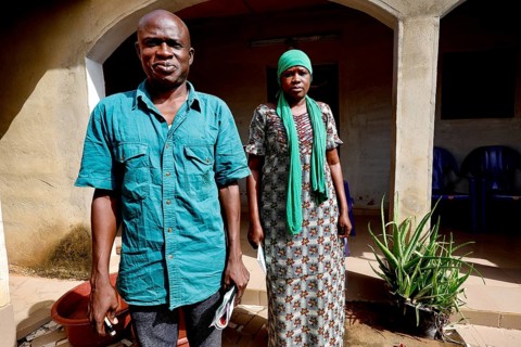 A man and a woman stand in front of their house, radiating strength together, Korhogo, CI, West