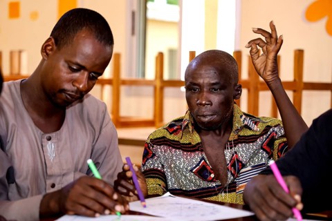 People in CI Korhogo focus on painting therapy with colorful pencils, Korhogo, CI, Côte d'Ivoire