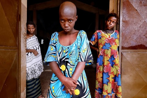 Three woman with different clothes stand in a door and look calmly at the camera, Bouké, region,