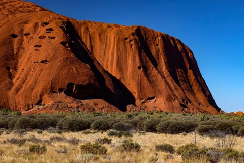 Close-up of Uluru with bright red rock under blue sky, Uluru, Northern Territory, Australia
