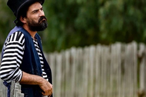 A performer wearing traditional dress looks seriously into the distance, Ballarat, Australia