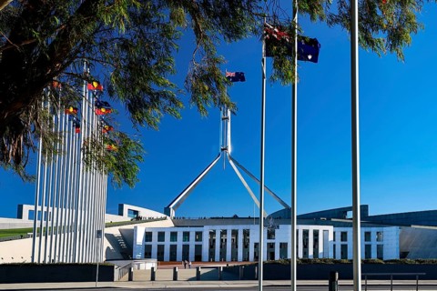 The Parliament House in Canberra, surrounded by flags and bright blue skies, Canberra, Australian