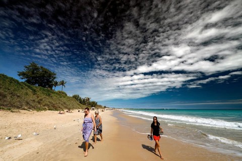 Group of people walking along sunny Cable Beach, Broome, Western Australia, Australia