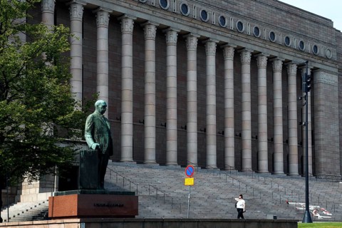 The Finnish Parliament in Helsinki with a statue and impressive pillars, Helsinki, Uusimaa, Finland