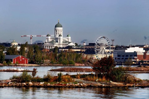 A view of Helsinki with cathedral and Ferris wheel behind an island offers a fascinating panorama,