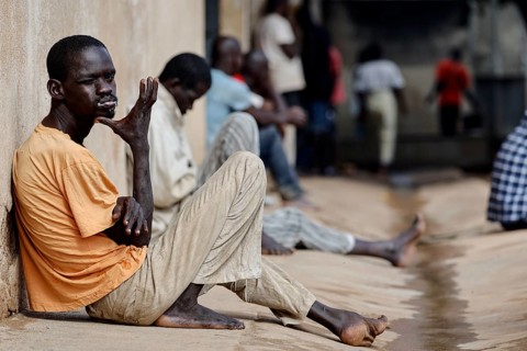 Patients sit on the wall of male psychiatry in quiet moments, Bouaké, Nimbo, Côte d'Ivoire