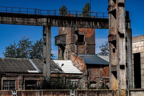 Former factory site with brick structures and blue sky, Daugavpils, Latvia