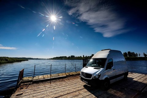 Sprinter on a ferry in bright sunshine across the Daugava, Dunava, Latvia