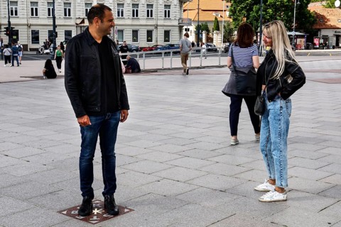A couple talking on the miracle tile on Cathedral Square in Vilnius, Vilnius, Vilnius County,