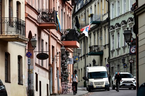 Busy street with cars and flags in the artistic district of Vilnius' Užupis, Vilnius, Užupis,