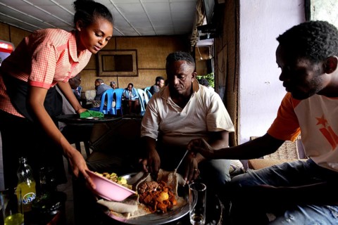 People enjoying a meal in a cozy restaurant setting, Bahirdar, Ethiopia
