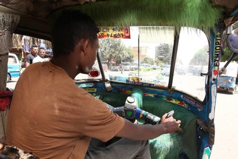 Driver drives a Bajaj taxi in busy city traffic, Bahirdar, Ethiopia