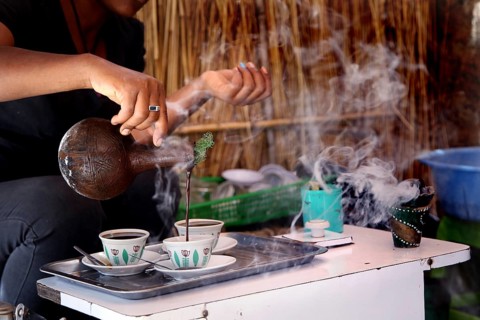 Traditional coffee ceremony with steaming coffee and cups, Axum, Ethiopia