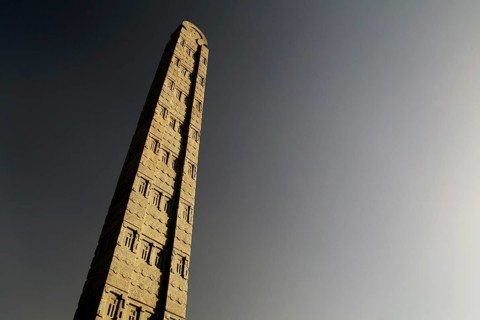 A tall, impressive stele rises majestically against the clear sky, Axum, Tigray, Ethiopia
