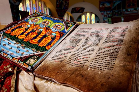 Bible inside St. Mary's Cathedral in Axum shows beautiful stained glass and detailed illuminations,