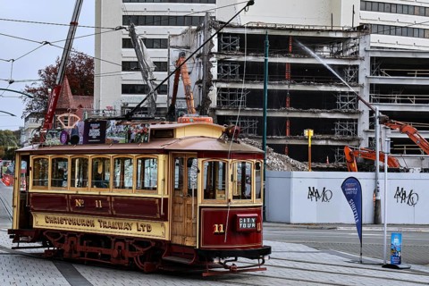 Historic tram in front of damaged buildings in Christchurch, Christchurch, Canterbury, New Zealand