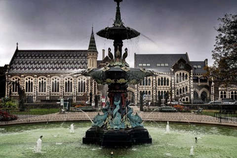 Impressive fountain in front of the Canterbury Museum in Christchurch under cloudy sky,