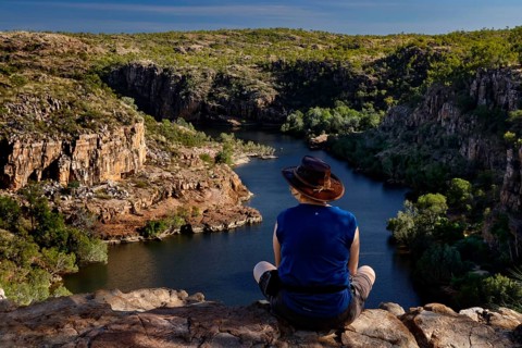 Person sitting on the edge looking at the river in Pat's Lookout, Nitmiluk National Park, Northern