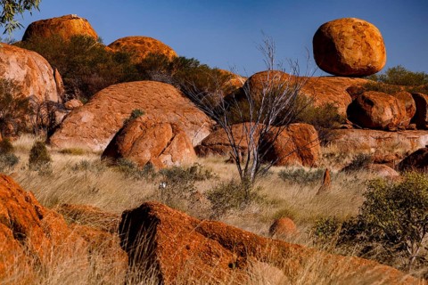 The distinctive, rounded rocks of Devil's Marbles, surrounded by sparse vegetation, Devil's