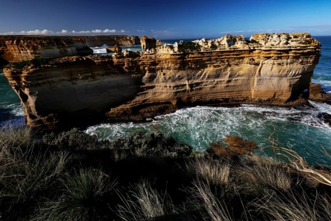 The impressive rock formation The Razorback on the Great Ocean Road surrounded by waves, Great