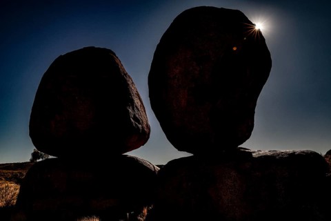 Silhouette of large rocks in sunlight that create a dramatic atmosphere in darkness, zero