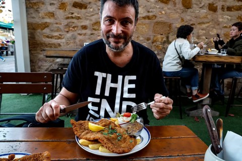 A man enjoying a schnitzel in a German restaurant in Hahndorf, Hahndorf, South Australia, Australia