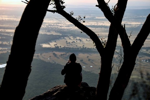 Tourist enjoying picturesque view from Boroka Lookout in the Grampian Mountains at sunset, Grampian