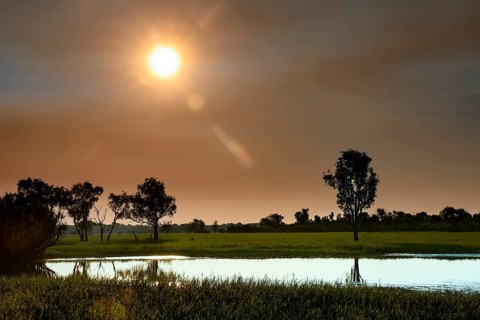 Idyllic sunset scene over Yellow Waters, Kakadu National Park, with reflecting water, Yellow Water,
