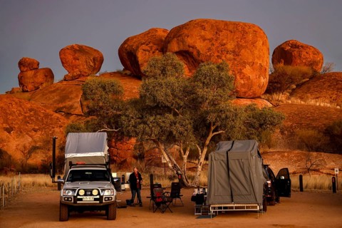 Campground in the evening surrounded by impressive red rock formations, Devil's Marbles, Northern