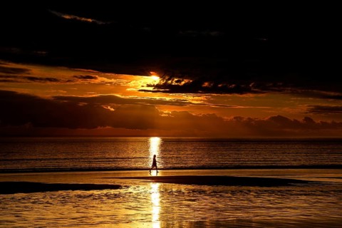 Golden sunset on Cable Beach with heavenly reflections in water, Broome, Western Australia,