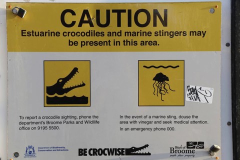 Warning sign on Cable Beach warns of crocodiles and jellyfish in the area, Broome, Western