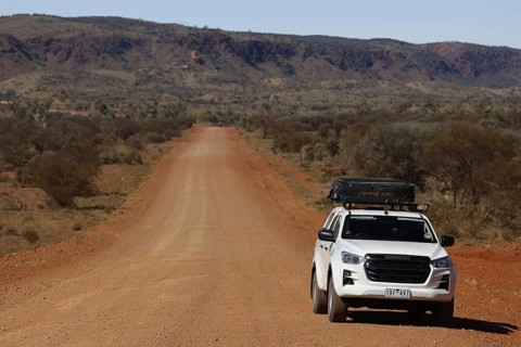Off-road vehicle on lonely road of Mereenie Loop Road, Mereenie Loop Road, Northern Territory,