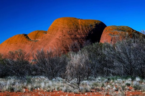 The Olgas with reddish rock formations against a clear sky, Kata Tjuta, Northern Territory,
