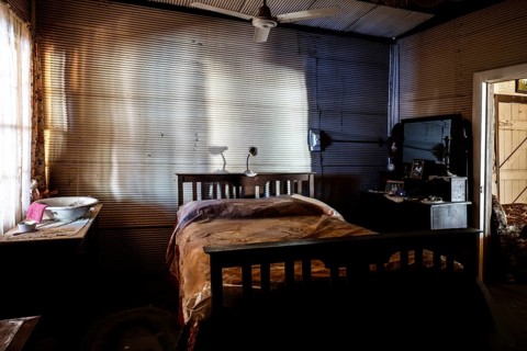 Subdued bedroom with old-fashioned bed and wooden furniture, zero