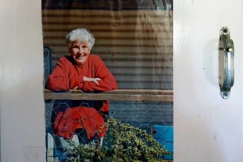 Portrait of Molly Clark in red outfit on the porch, zero