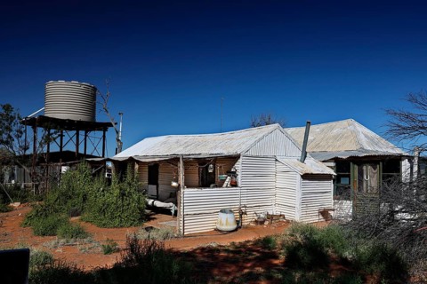 Old Andado Station water tank building under blue sky, Old Andado Station, Northern Territory,