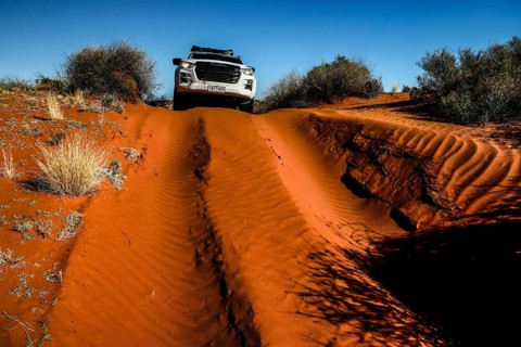 Off-road vehicle drives on sandy track through Simpson Desert, Simpson Desert, Australia