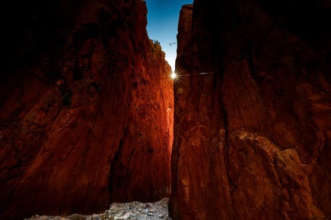 Dramatic rock formations of Standley Chasm with sunbeams shining through, Standley Chasm, Northern