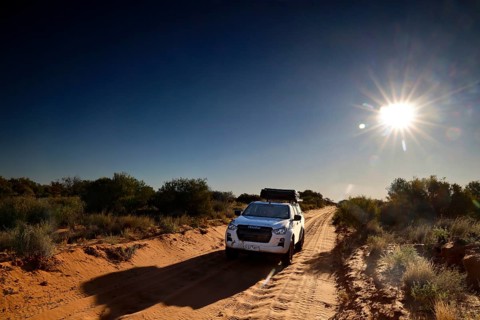 4WD vehicle at sunrise on a desert track in the Simpson Desert, Simpson Desert, Australia
