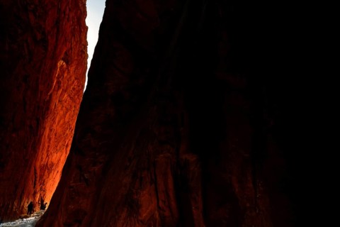 Sunlight falls on the red rocks of Standley Chasm in a dramatic scene, Standley Chasm, Northern