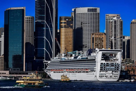 Large cruise ship in harbor in front of the impressive skyline of Sydney, Sydney, New South Wales,