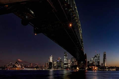 Nighttime view of illuminated Sydney Harbour Bridge and Opera Houses, Sydney, New South Wales,