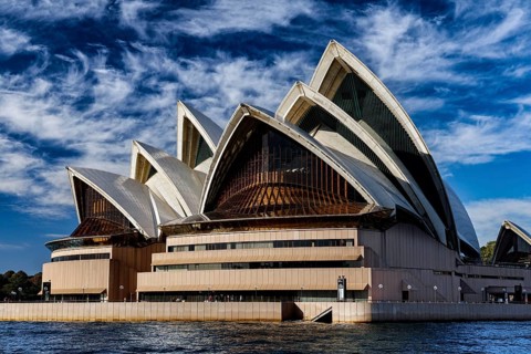 Sydney Opera House with characteristic sails against a blue sky, Sydney, NSW, Australia