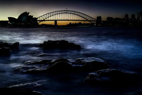 Silhouette of Sydney Opera House and Harbour Bridge at dusk, Sydney, New South Wales, Australia